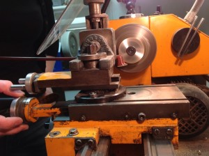Use middle dial to push bow into saw blade
