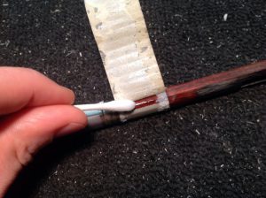 Mineral spirits on a q-tip help remove sticky tape and reduce the chance of tearing out any wood during removal.